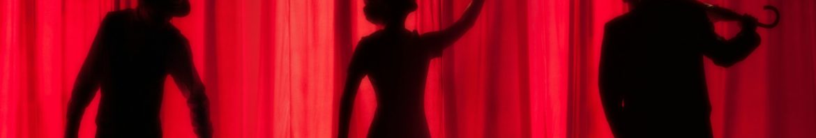 silhouettes sur fond de rideau rouge de théâtre